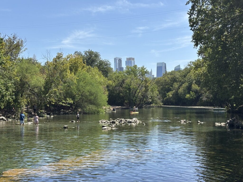 Barton Creek with downtown Austin skyline visible through the trees, Zilker neighborhood