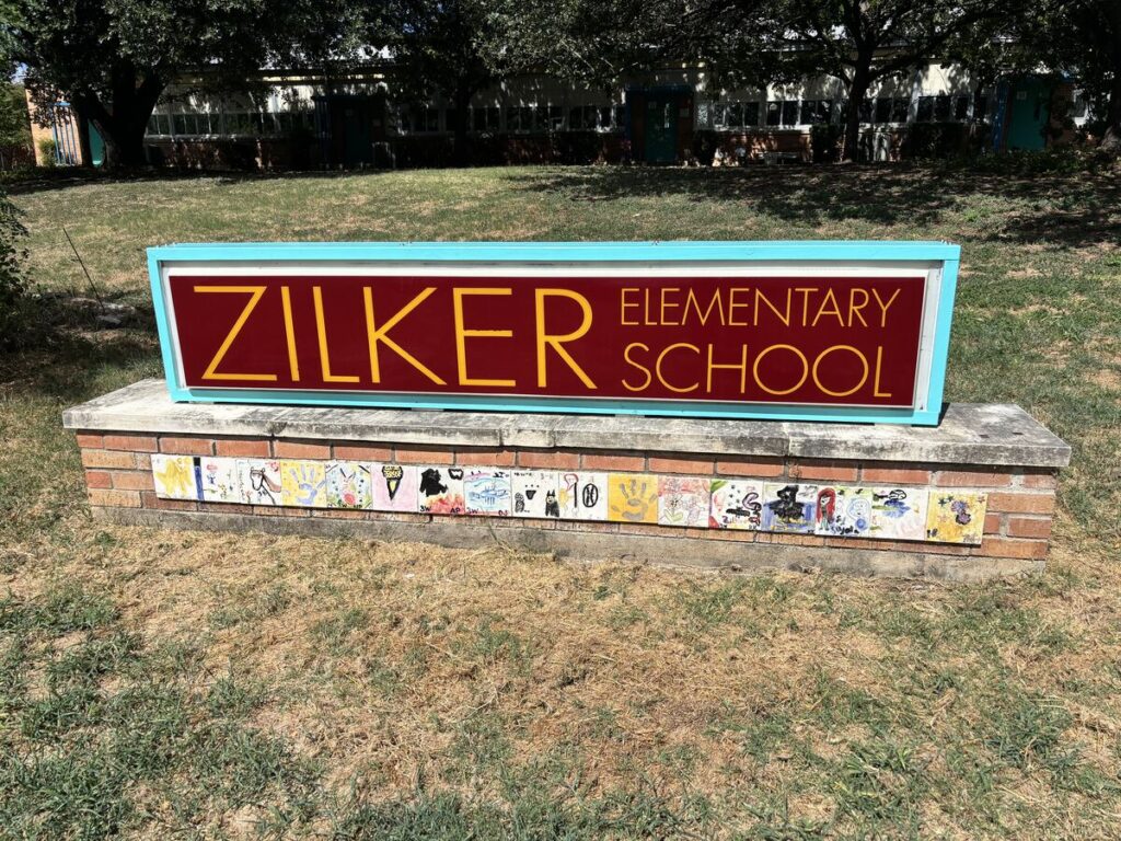 Zilker Elementary School sign on the front lawn of the campus